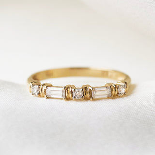 Moissanite and diamond wedding band in gold