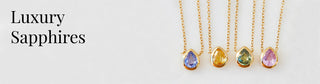 Carrie Elizabeth luxury sapphires banner. Featuring 4 Carrie Elizabeth sapphire necklaces – blue sapphire, yellow sapphire, green sapphire, & pink sapphire all crafted in solid yellow gold.