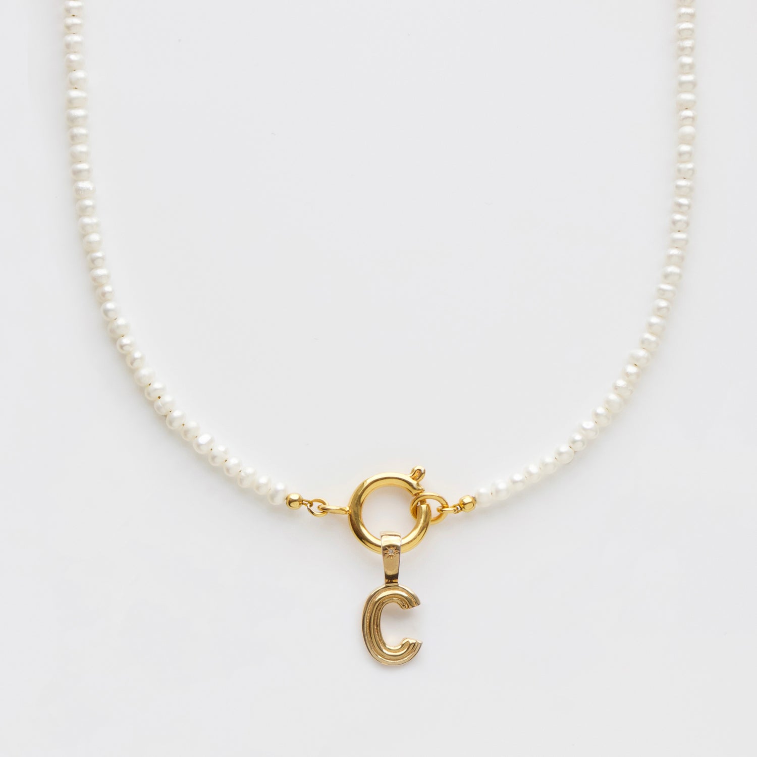pearl and initial front facing necklace in gold with diamond
