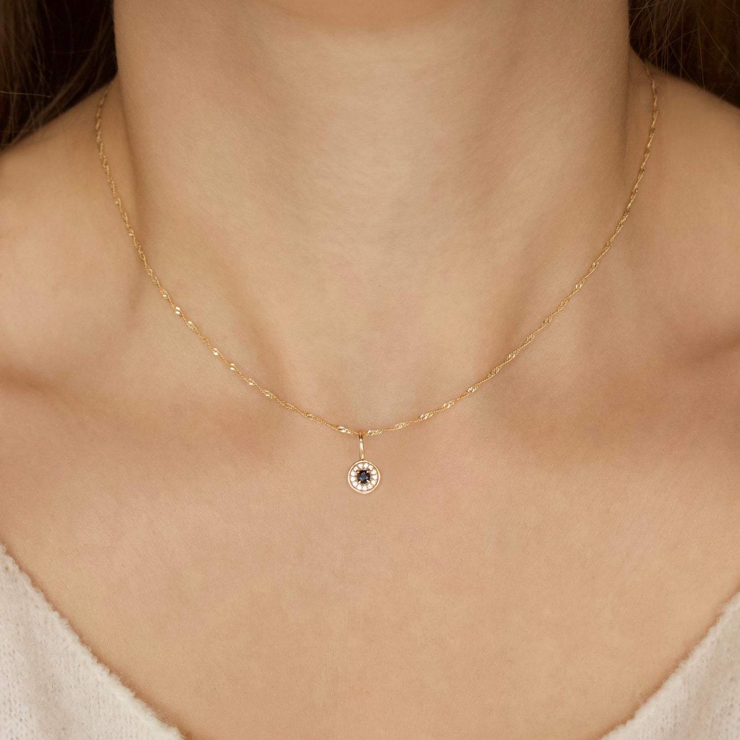 evil eye charm in solid gold and sapphire