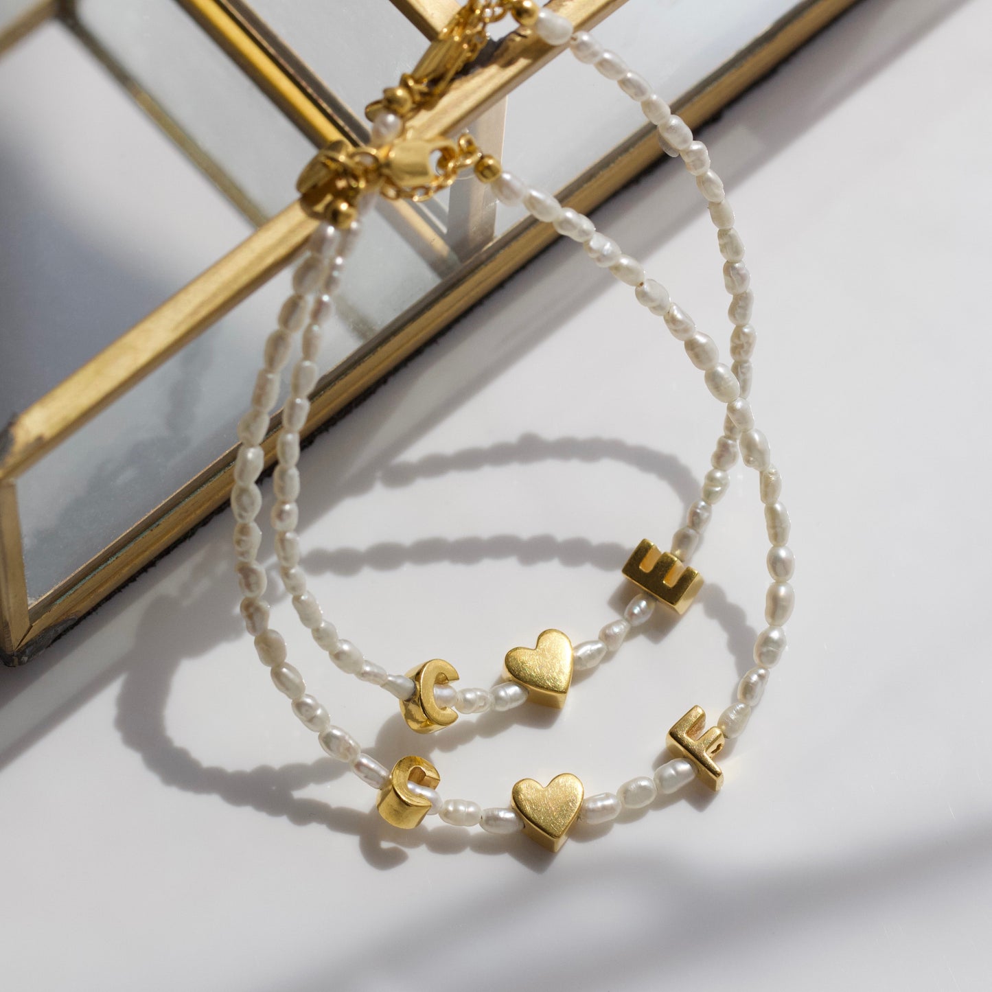 personalised pearl initial bracelet in gold