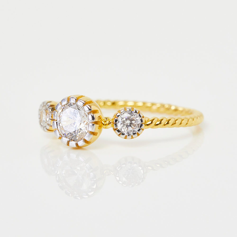 cz stone ring with twisted band detail in gold