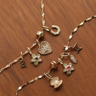 Birthstone flower charms in solid gold