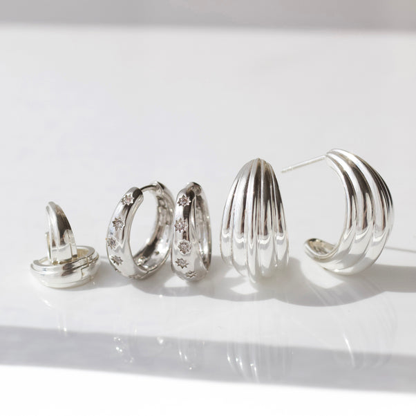 celestial rhodium plated tapered hoop earring with cz