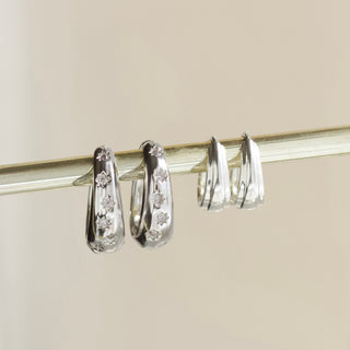 celestial rhodium plated tapered hoop earring with cz