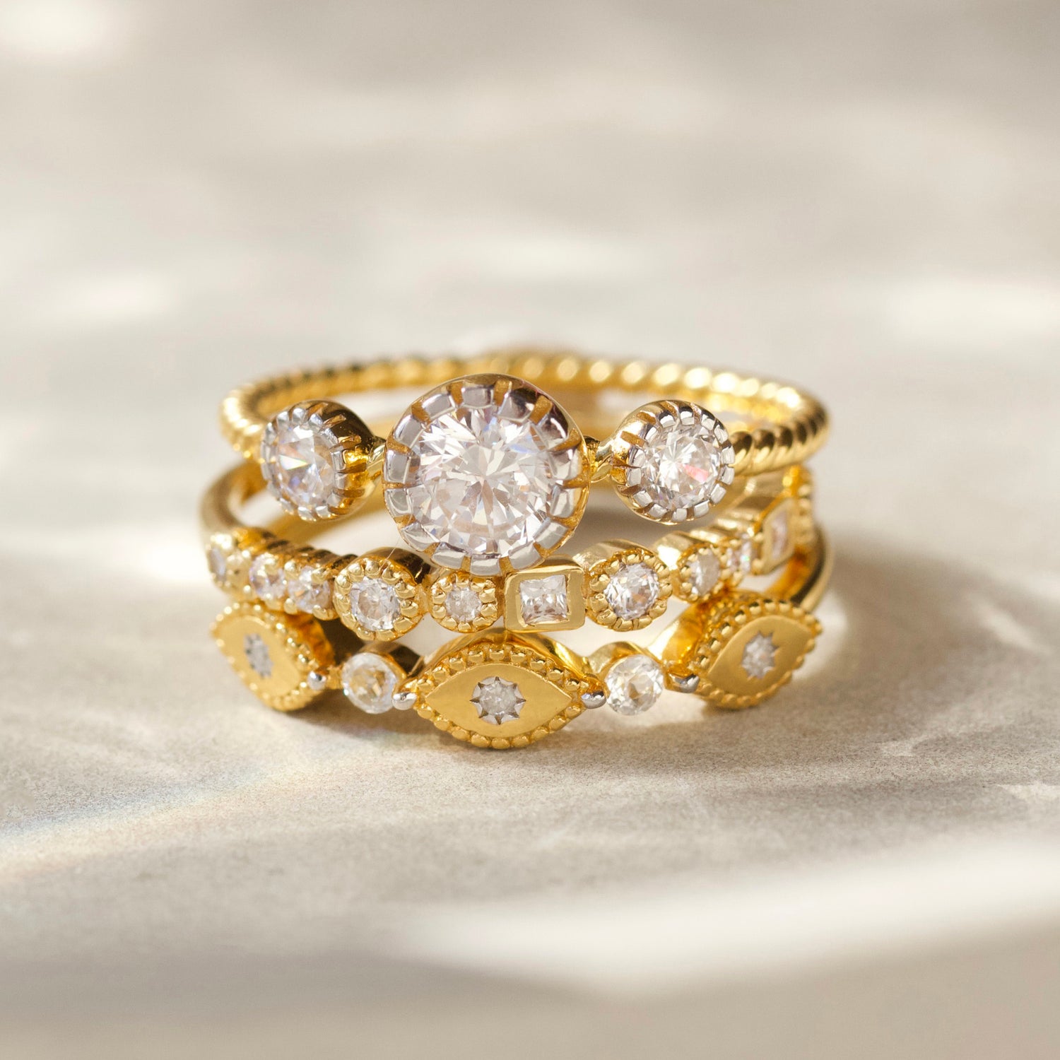 cz stone ring with twisted band detail in gold