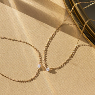 floating drilled diamond necklace in solid gold