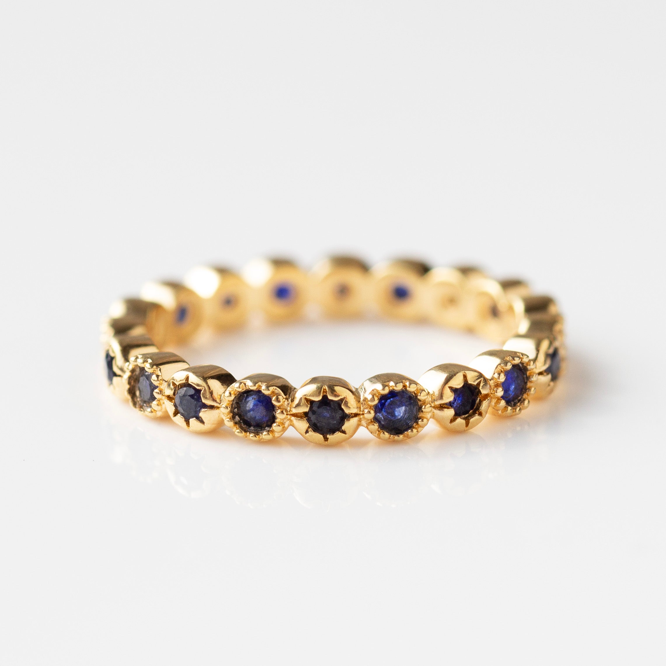 blue sapphire eternity ring in gold