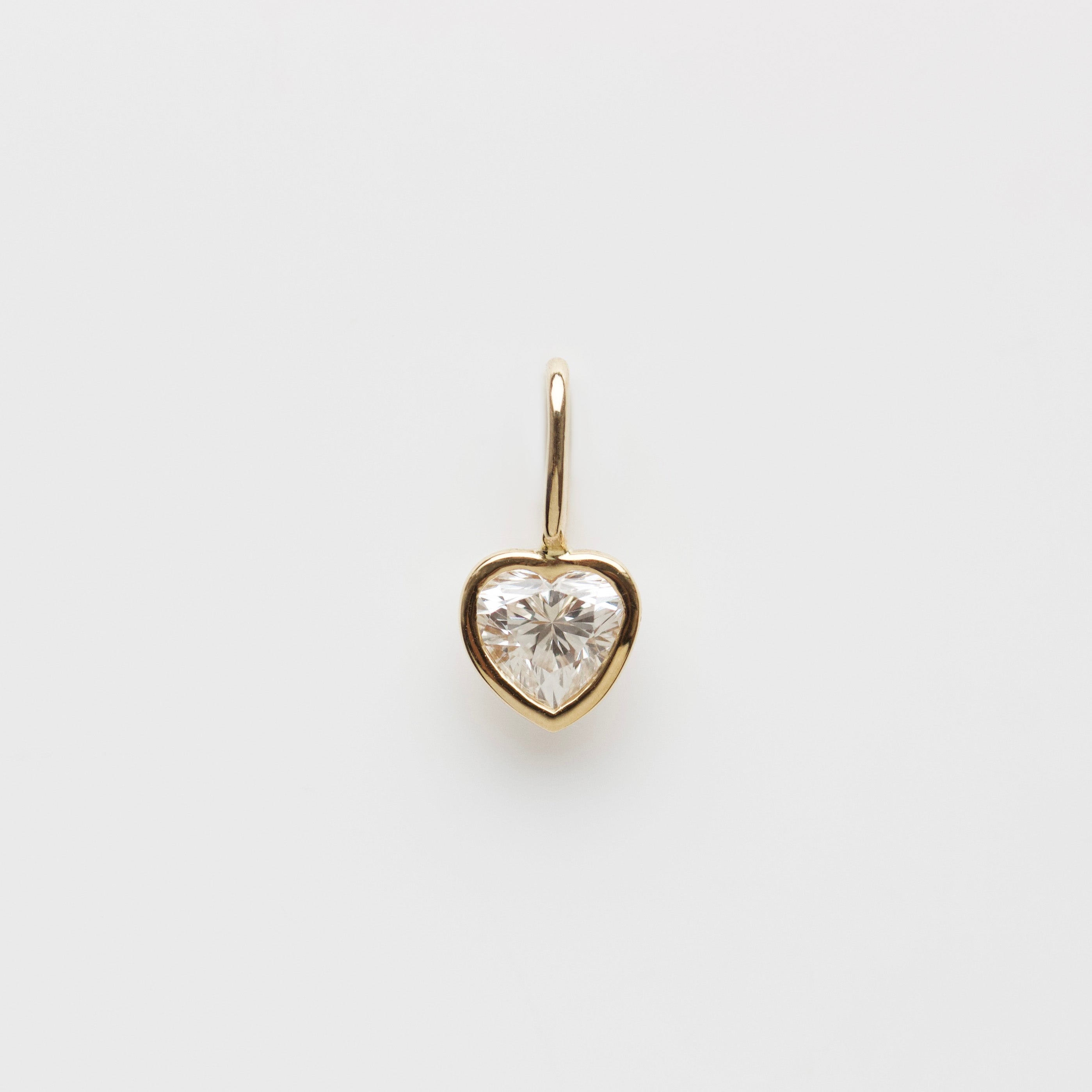 Diamond heart charm in solid gold