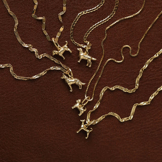 Dog charm in sold gold